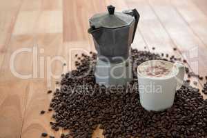 Coffeemaker with coffee beans and coffee mug