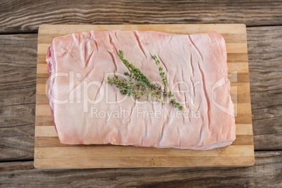 Beef brisket and herb on wooden tray against wooden background