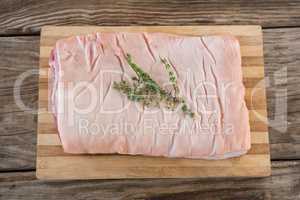 Beef brisket and herb on wooden tray against wooden background