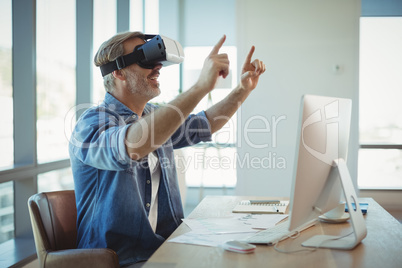 Male executive using virtual reality headset