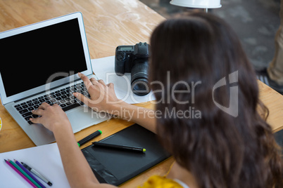 Female graphic designer using laptop