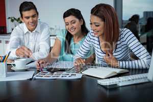 Graphic designers  discussing over photographs