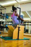 Determined woman exercising on wunda chair