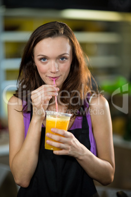 Shop assistant having fresh fruit juice