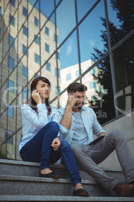 Executives listening music on digital tablet