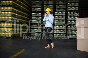 Female factory worker talking on mobile phone