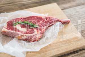 Rib chop and rosemary herb on wooden tray