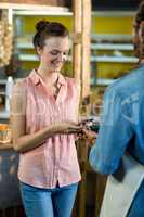 Woman making a payment by using NFC technology