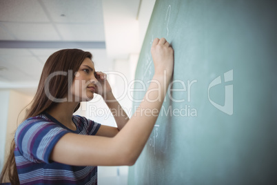 Schoolgirl pretending to be a teacher in classroom