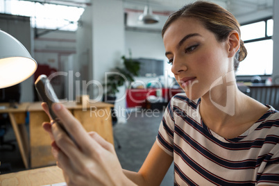 Female graphic designer using mobile phone Female graphic designer using mobile phone