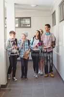 Group of classmate walking in corridor