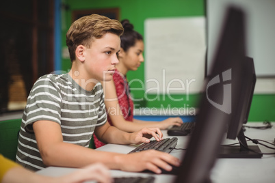 Students studying in computer classroom