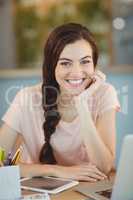 Portrait of beautiful business executive sitting at desk