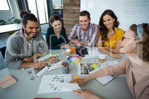 Graphic designers discussing with each other in meeting