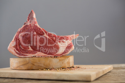 Beef ribs rack and spices on wooden tray against wooden background