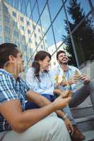 Executives having breakfast outside office building