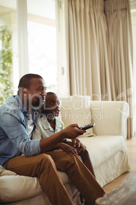 Son and father watching television