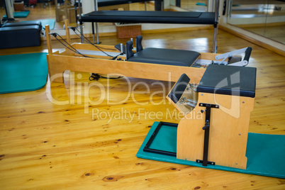 Reformer and wunda chair on wooden floor