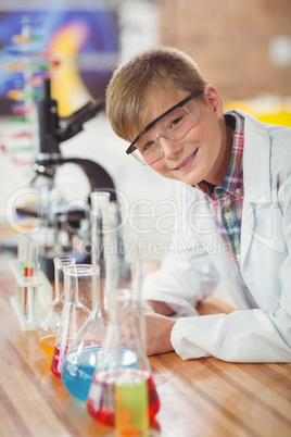 Portrait of schoolboy doing a chemical experiment in laboratory