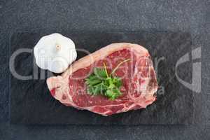 Sirloin chop and garlic on slate plate