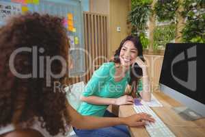 Business executive sitting at desk together