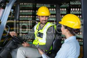 Factory workers interacting with each other in factory