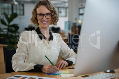 Female graphic designer working at desk