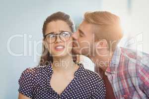 Affectionate man kissing woman