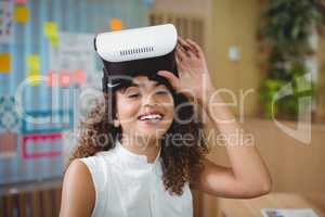 Portrait of female business executive using virtual reality headset