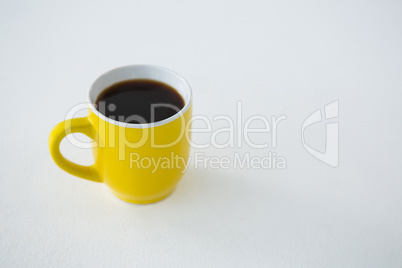 Black coffee served in yellow cup