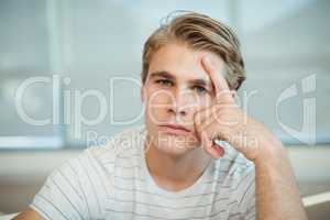 Thoughtful business executive sitting with hand on forehead