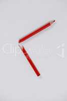 Red broken colored pencil on white background