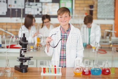 Portrait of smiling schoolboy in laboratory