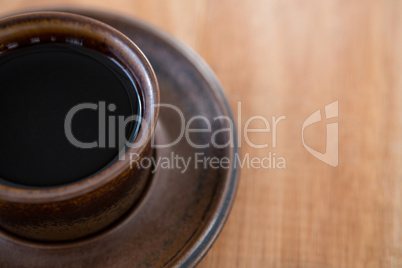 Black coffee served in brown cup