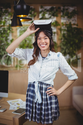 Portrait of female business executive using virtual reality headset