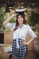 Portrait of female business executive using virtual reality headset