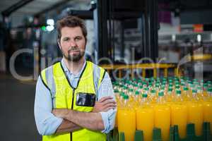 Portrait of factory worker standing with arms crossed