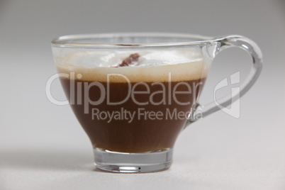 Transparent coffee cup with creamy froth