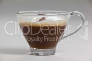 Transparent coffee cup with creamy froth