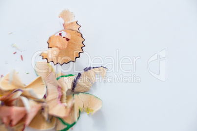 Colored pencils shavings on a white background