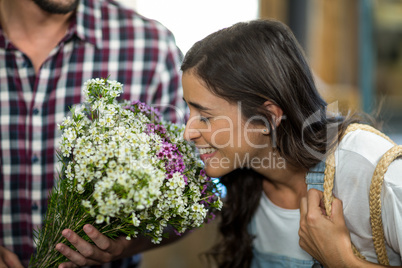 Couple selecting flowers at florist shop