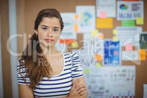 Portrait of female executive standing with arms crossed