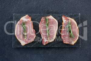 Sirloin chops and rosemary herb on slate plate