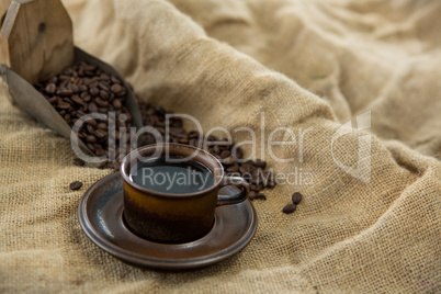 Black coffee, roasted beans and scoop on sack