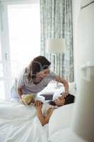 Mother making her daughter sleep in bedroom