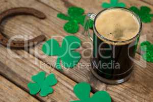 Glass of black beer, horseshoe and shamrock for St Patricks Day