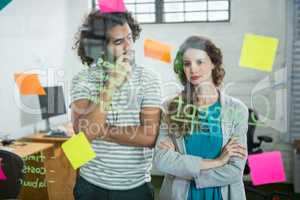 Thoughtful executives looking at sticky note