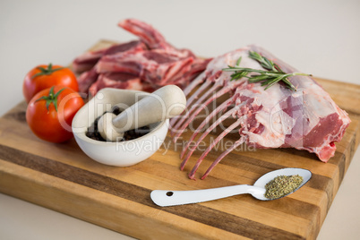 Rib rack, rib chop and ingredients on wooden board