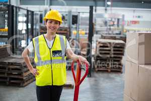 Portrait of female worker standing with hand on hip