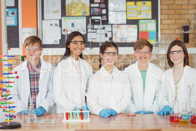 Portrait of school kids doing a chemical experiment in laboratory